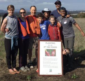 volunteers with planting sign