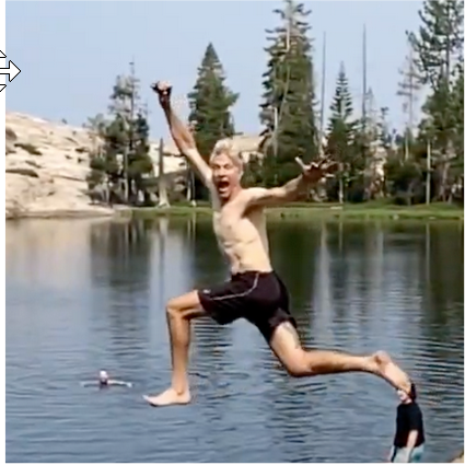 Leader Sven jumping into mountain lake